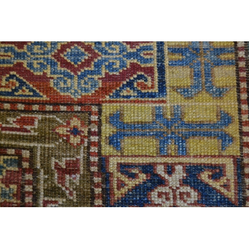 20 - Small Kazak pattern rug of floral and multiple border design, 3ft 6ins x 2ft 6ins approximately