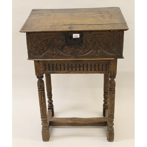 2056 - 17th Century oak bible box, the hinged sloping plank top above a carved panel front, raised on a lat... 