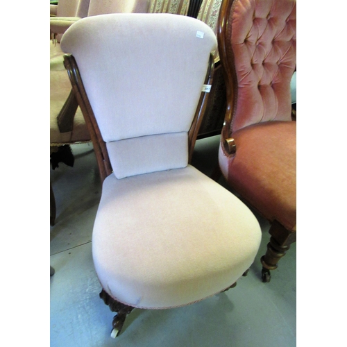 2057 - Victorian carved walnut nursing chair with a padded back and an overstuffed seat, on cabriole suppor... 