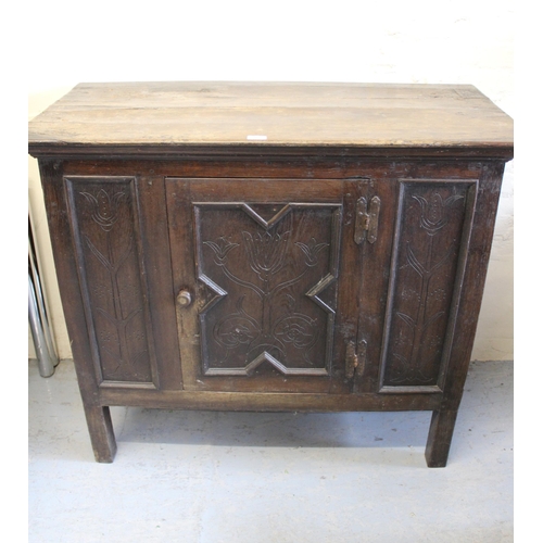 2060 - Antique oak side cabinet, the moulded plank top above a single geometrically moulded panel door carv... 