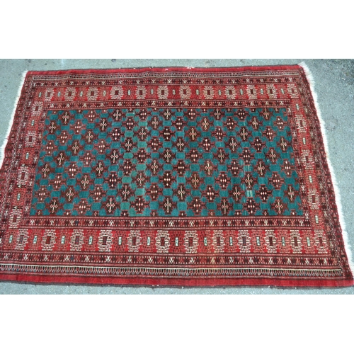 23 - Small 20th Century Turkoman rug with an all-over stylised flower head design on a blue / green groun... 