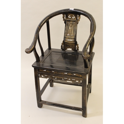 2303 - Chinese ebonised wishbone type chair with carved panel back, panel seat and square supports