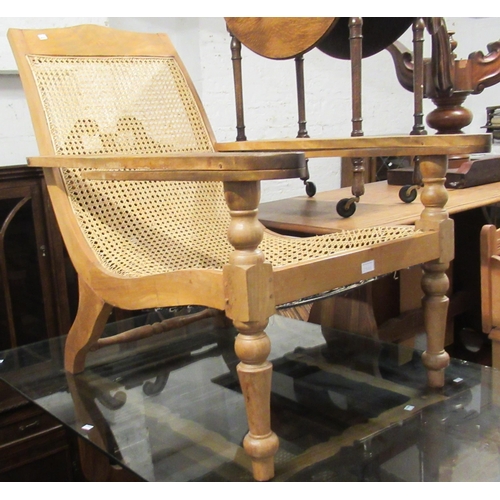 2325 - Hardwood plantation type chair with folding arms and cane seat, together with a pair of similar open... 