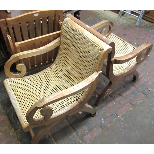 2325 - Hardwood plantation type chair with folding arms and cane seat, together with a pair of similar open... 