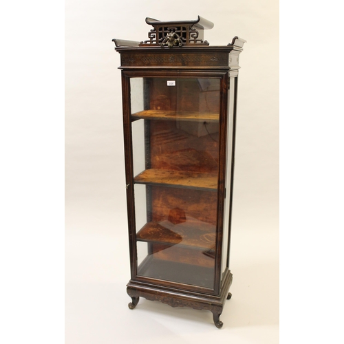 2328 - Early 20th Century Japanesque display cabinet, the shaped surmount above a single glazed door enclos... 