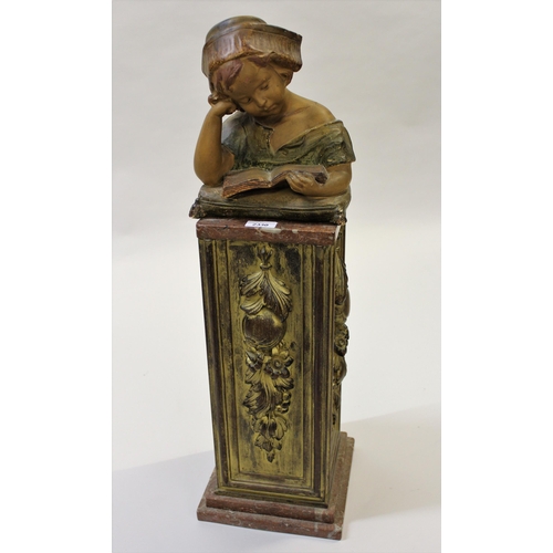 2330 - Painted plaster bust of a child reading a book, mounted on a giltwood and marble plinth (damages and... 