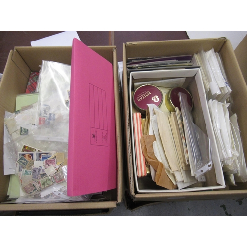 238 - Two boxes containing a collection of World and Commonwealth stamps in packets and on album pages etc