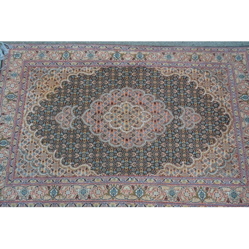 25 - Small Indo Persian rug with a lobed medallion and all-over Herati design on a moss green ground with... 