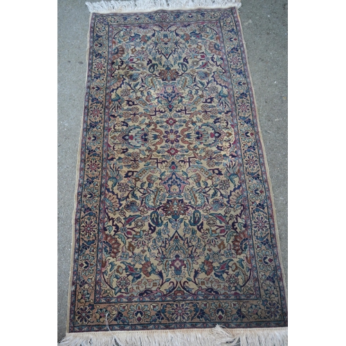 26 - Small Indo Persian rug with an all-over floral design on a ivory ground with borders, 5ft 5ins x 2ft... 