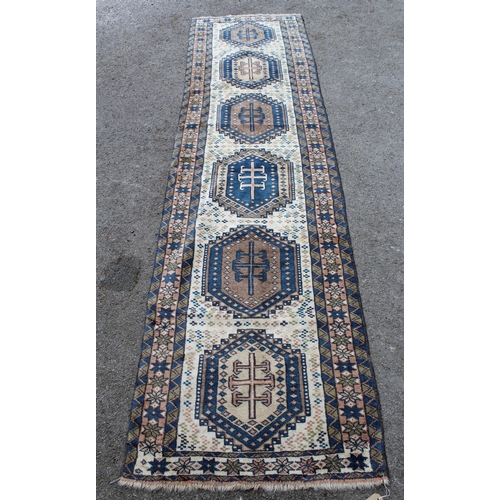 3 - Modern Turkish runner with six medallions on a cream ground with borders, 9ft 4ins x 2ft 6ins approx... 