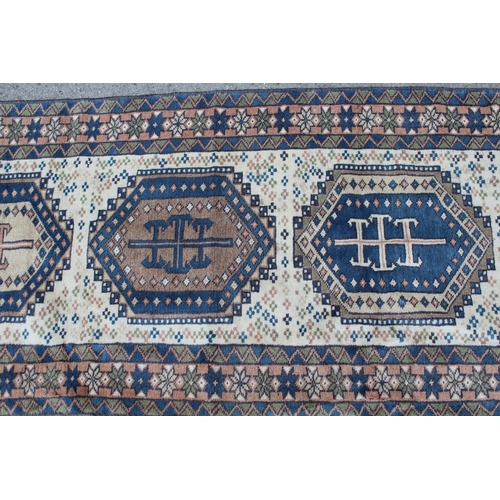 3 - Modern Turkish runner with six medallions on a cream ground with borders, 9ft 4ins x 2ft 6ins approx... 