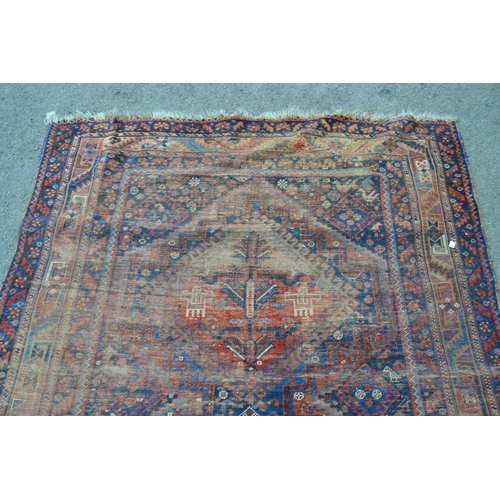 32 - Shiraz rug with triple medallion design (extensive wear) 8ft 10ins x 5ft approximately