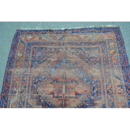 32 - Shiraz rug with triple medallion design (extensive wear) 8ft 10ins x 5ft approximately