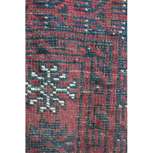 33 - Afghan carpet with rows of nine gols on a wine red ground, with multiple borders, 8ft 8ins x 7ft 8in... 