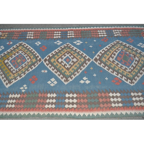36 - Kelim rug with a triple medallion design on pale blue ground with borders, 7ft x 4ft 6ins approximat... 