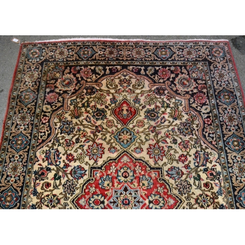 37 - Tabriz rug with a medallion and all-over floral design on an ivory ground with blue ground rosette b... 