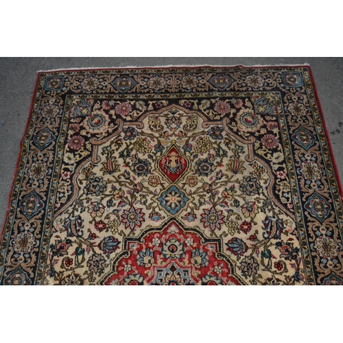 37 - Tabriz rug with a medallion and all-over floral design on an ivory ground with blue ground rosette b... 