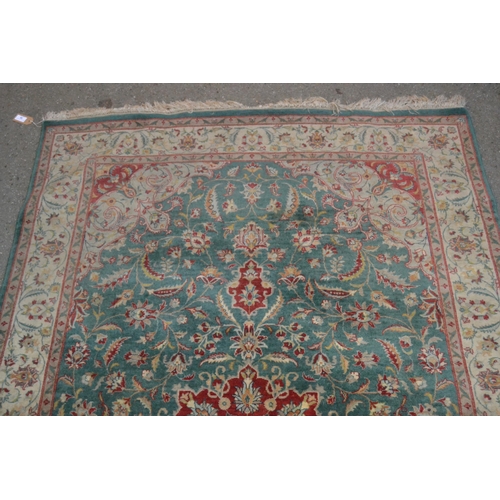 38 - Indo Persian rug with  lobed medallion and all-over stylised floral design on a blue / green ground ... 
