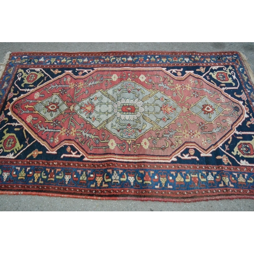 39 - Hamadan rug with a lobed medallion and stylised floral design on a rose ground with deep blue corner... 