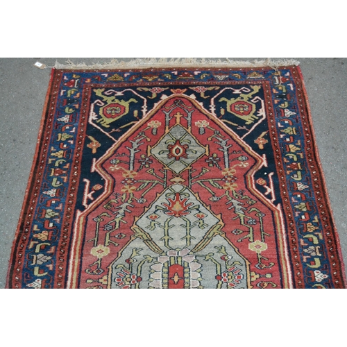 39 - Hamadan rug with a lobed medallion and stylised floral design on a rose ground with deep blue corner... 