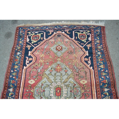 39 - Hamadan rug with a lobed medallion and stylised floral design on a rose ground with deep blue corner... 