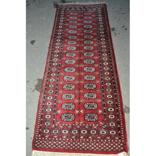 43 - Pakistan Turkoman design runner having two rows of gols with multiple borders on a red ground, 230 x... 