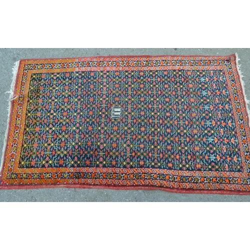 47 - Small Hamadan rug of all-over floral design and multiple borders, on a dark blue ground, 32ins x 52i... 