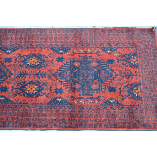 54 - Modern Afghan Belouch runner with a triple medallion and all-over design on a rust ground with multi... 