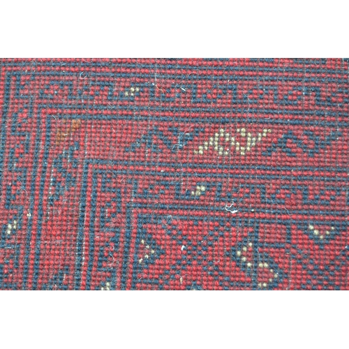 58 - Afghan carpet with four rows of seven gols on a wine ground with multiple borders, 9ft 6ins x 6ft 8i... 