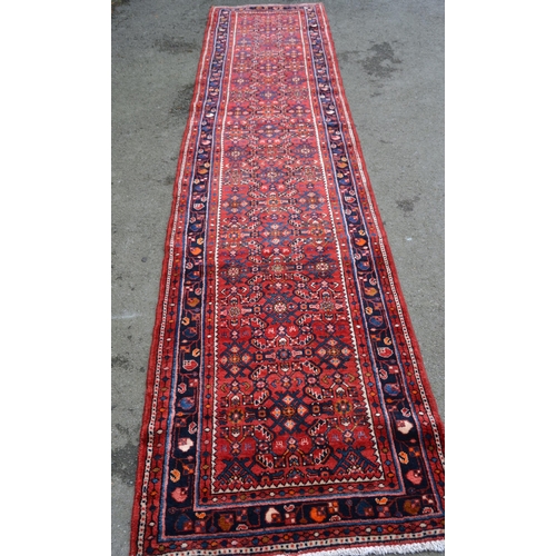 59 - Modern Hamadan runner with an all-over Herati design on a red ground with borders, 13ft x 3ft approx... 