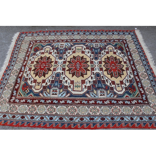 6 - Caucasian flatweave rug of Soumak type, with a triple medallion design in shades of red, yellow ochr... 