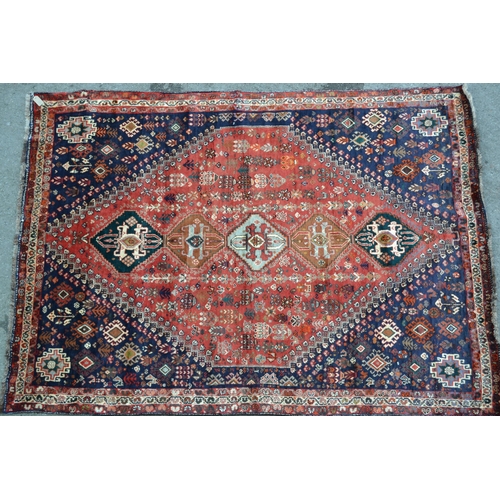 60 - Modern Qashqai carpet with a five medallion and all-over stylised floral design on a red ground, wit... 