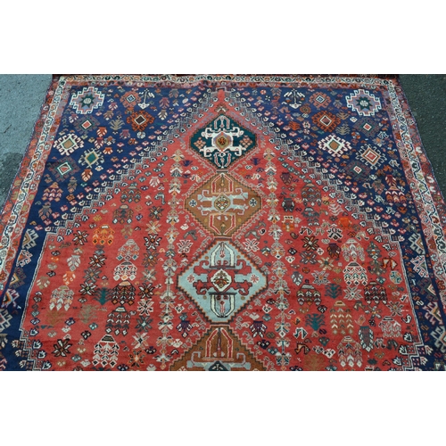 60 - Modern Qashqai carpet with a five medallion and all-over stylised floral design on a red ground, wit... 