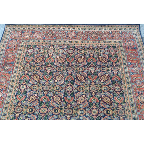 61 - Indo Persian rug with an all-over Herati design on a midnight blue ground with brick red borders, 8f... 