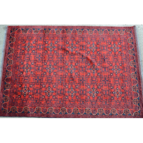 62 - Modern Afghan carpet with three rows of five gols on a wine ground with borders, 9ft 2ins x 6ft 8ins... 