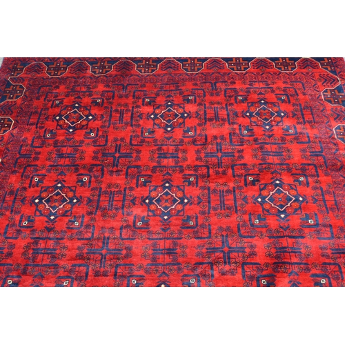 62 - Modern Afghan carpet with three rows of five gols on a wine ground with borders, 9ft 2ins x 6ft 8ins... 