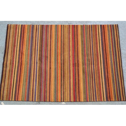 67 - Modern Tibetan rug woven with a polychrome stripe design in shades of red, orange, green, beige and ... 