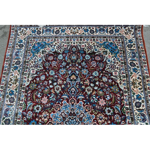 68 - Modern Qum style rug with a lobed medallion and all-over palmette design on a deep red ground, with ... 