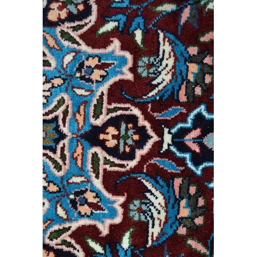 68 - Modern Qum style rug with a lobed medallion and all-over palmette design on a deep red ground, with ... 