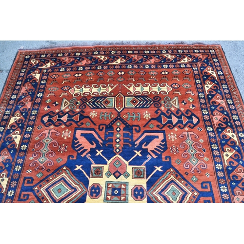 69 - Modern Kazak carpet with a central medallion and all-over stylised hooked design on a rust ground wi... 