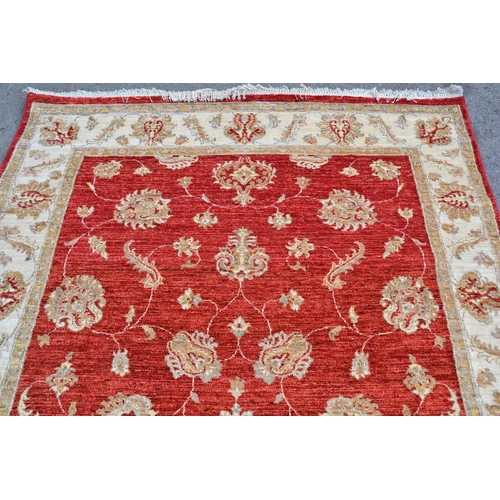 70 - Modern Afghan Ziegler design rug with an all-over palmette pattern on a red ground with beige ground... 