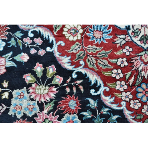 73 - Fine quality modern Persian silk carpet with a lobed medallion and all-over stylised floral design o... 