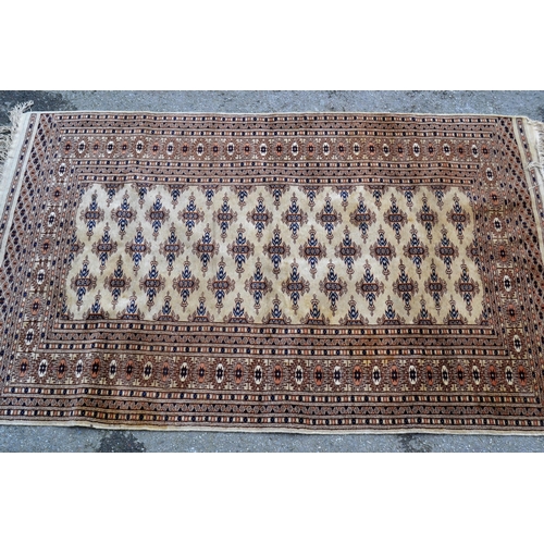 76 - Small Pakistan rug of Turkoman design with three rows of gols on a beige ground with borders, 5ft 3i... 