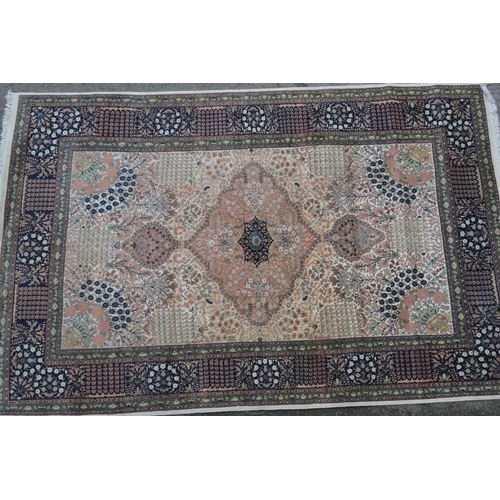 80 - Kashmiri part silk rug with a lobed medallion and all-over floral design on an ivory ground with mid... 