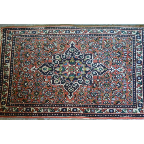 83 - Small Indo Persian mat with a medallion and all-over Herati design on a rose ground, 2ft 6ins x 1ft ... 