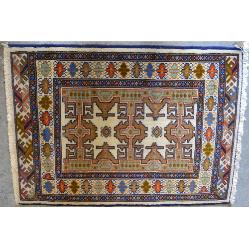 84 - Small Pakistan mat of Turkoman design, together with another similar, smaller