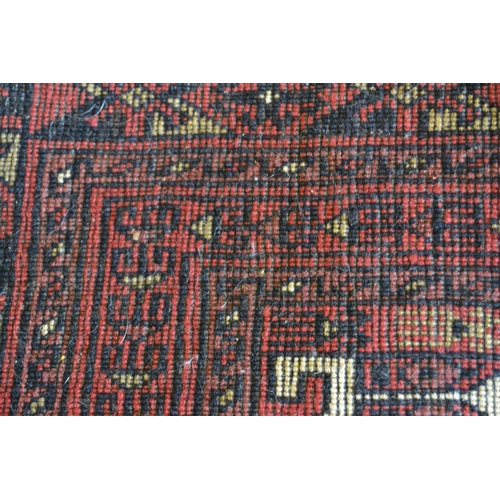 85 - Belouch rug with a central panel design and multiple borders with red ground, 4ft 8ins x 3ft 2ins ap... 