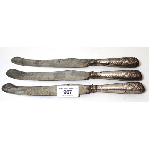 967 - Group of three George III steel bladed knives with silver covered handles (at fault)