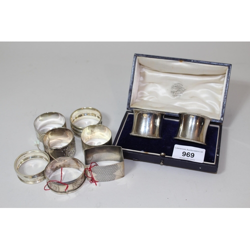 969 - Pair of silver napkin rings in original box and seven other various silver napkin rings