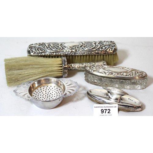 972 - Two silver mounted brushes, dressing table box, nail buffer and a silver tea strainer on stand